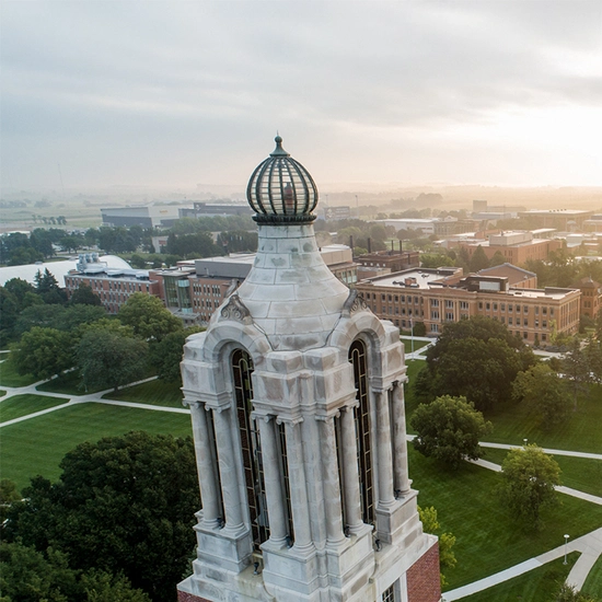 Aerial close up Coughlin Campanile with the campus in the background.