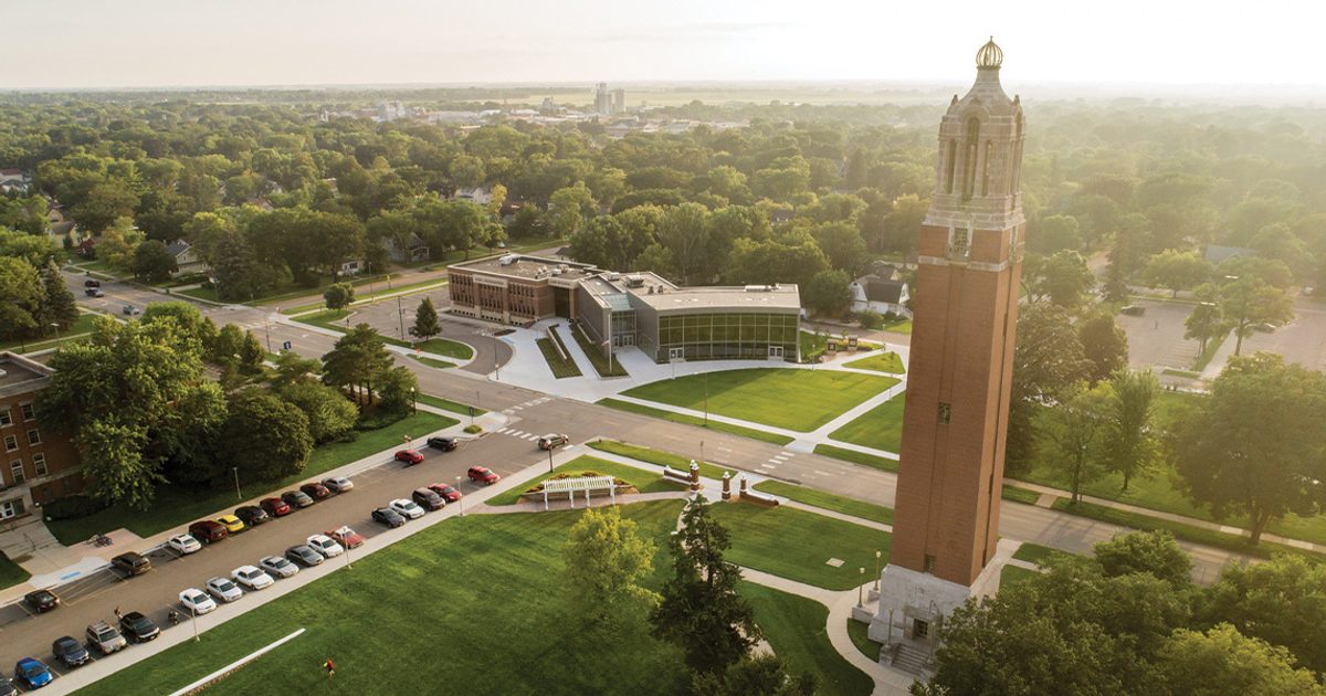 Aerial view of SDSU's campanile in the foreground and the SDSU Alumni Center behind it.