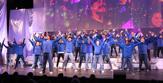 SDSU choir singing with their hands spread out in the air.