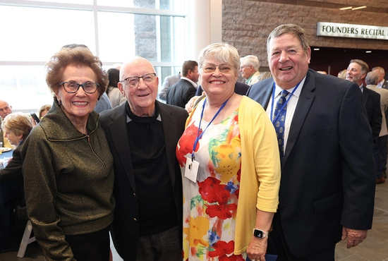 Four donors stand smiling together at the Celebration of Philanthropy.