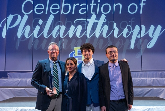 Four members of the Wintrode family smile with their Philanthropic Family of the Year award.