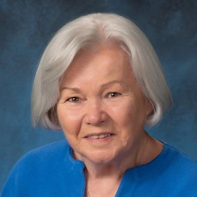 A professional headshot photo of Joan Hogan.