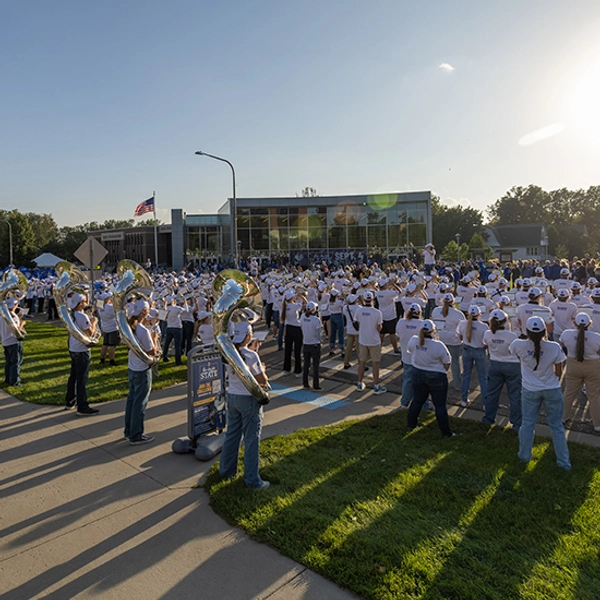 The Pride of the Dakotas stands on Medary Avenue, playing for the crowd at the Yellow & Blue Block Party.