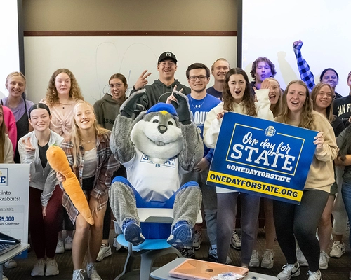 Large group of SDSU students smile with Jack during One Day for STATE