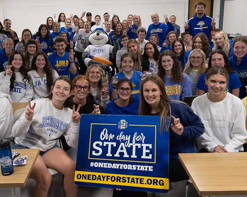 Large group of students in a classroom gathered together with Jack the Jackrabbit during One Day for STATE
