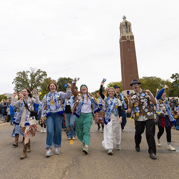 The Hobo Day committee walks down Medary Avenue during the parade with the Campanile in the background.