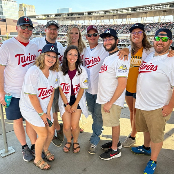A group of people at a Minnesota Twins' game wearing Twins and Jackrabbits jerseys.