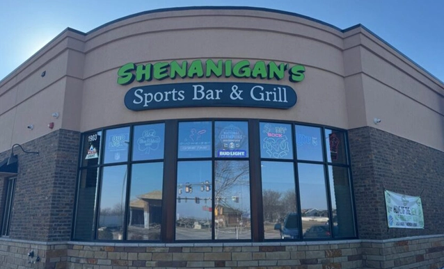Exterior building signage that reads Shenanigans Sports Bar and Grill.