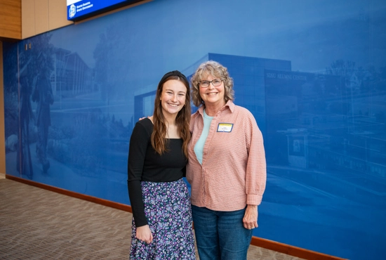 A photo of an SDSU student with her alumni mentor smiling for the camera.