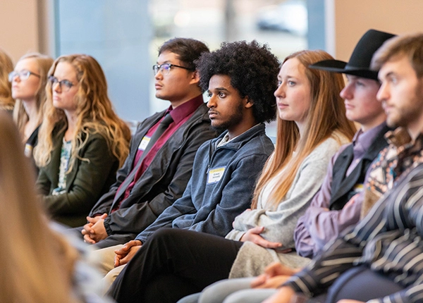 A line of SDSU students sitting at an Alumni Mentor Program event at the SDSU Alumni Center
