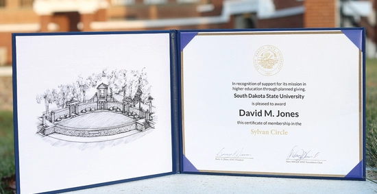 Sylvan Circle certificate sample with the Sylvan Theatre blurred in the background