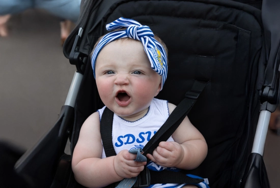 A baby wearing an SDSU outfit.