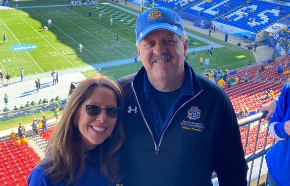 Lorie and Kevin Haarberg smiling in the stands at the FCS Football National Championship game