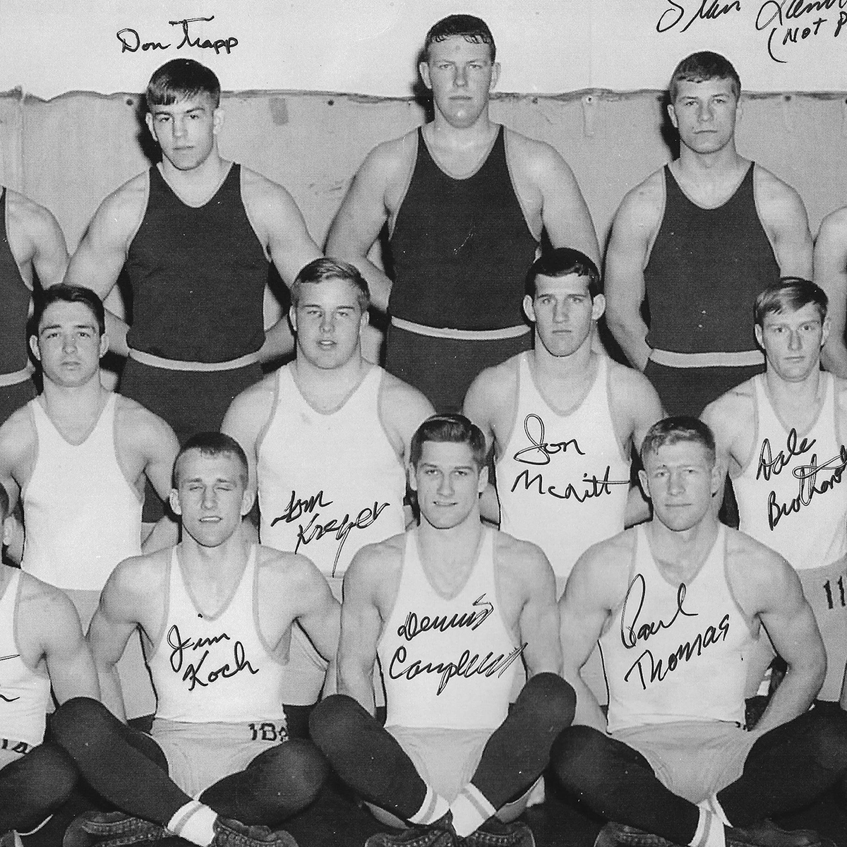 An old photo of a wrestling team with autographs