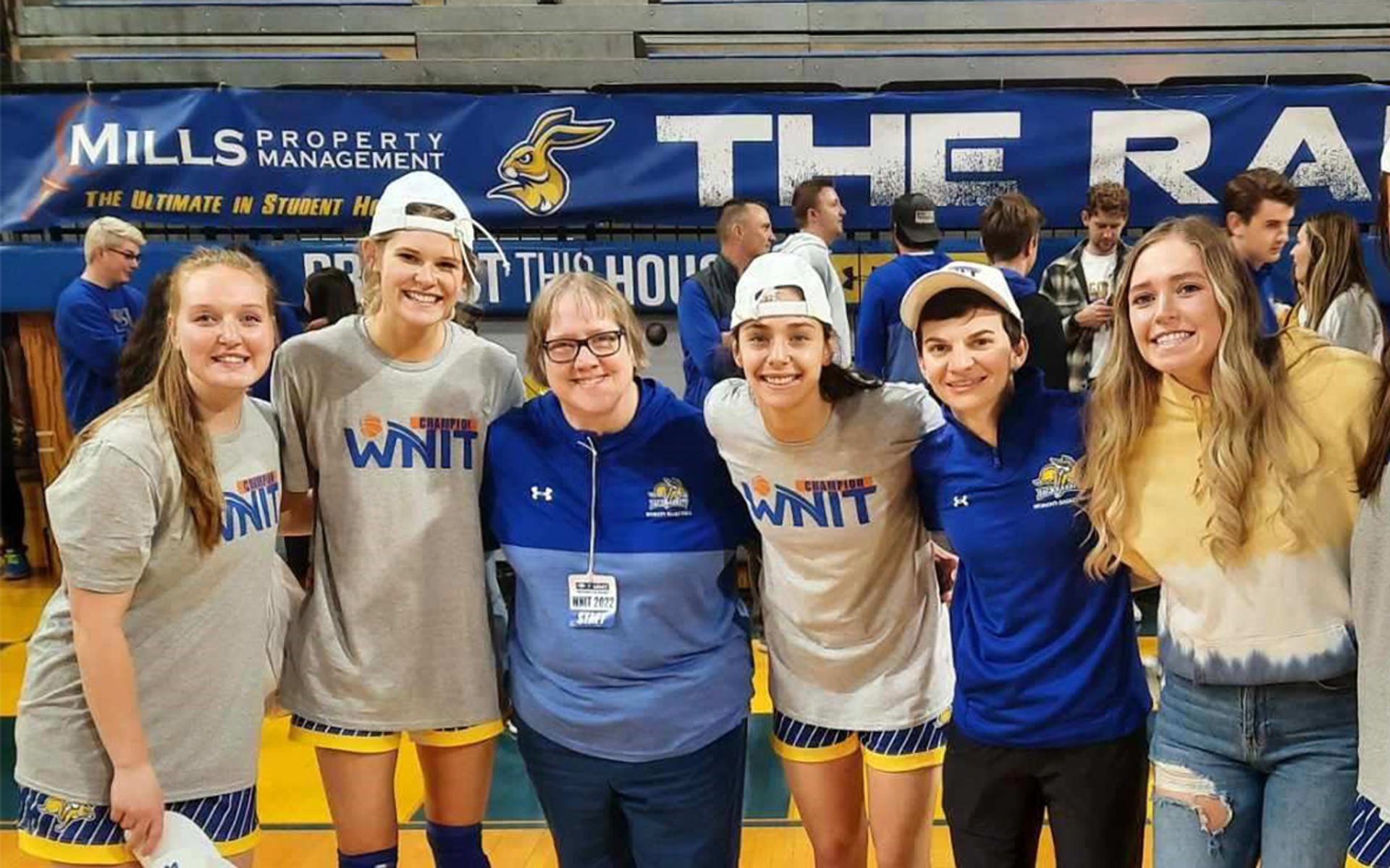 Sonja Anderson smiles while surrounded by members of the SDSU women's basketball team