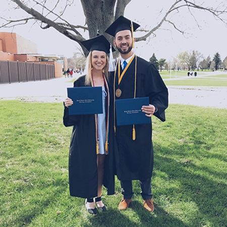 Allie and her husband in their SDSU graduation cap and gown