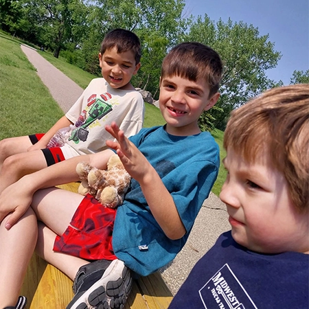 Ashley Ritter's 3 boys with grass in the background