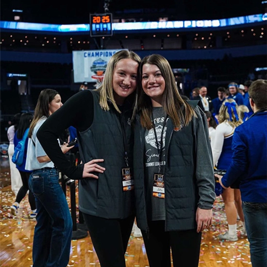 cadence koenig and a friend smiling together after the summit league championship game