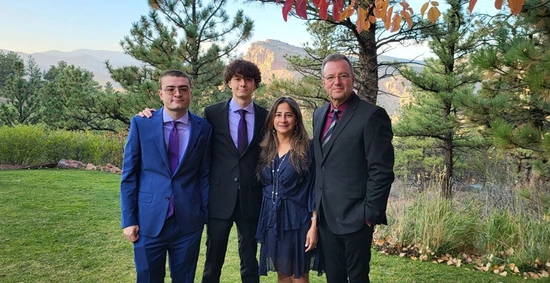 The Wintrode family smiles for the camera with a nice scenic mountain background.