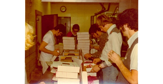 Vintage photo from the 1960's or 70's of SDSU students packing up cheese boxes.