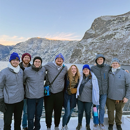 group of sdsu choir members with fjords in the background