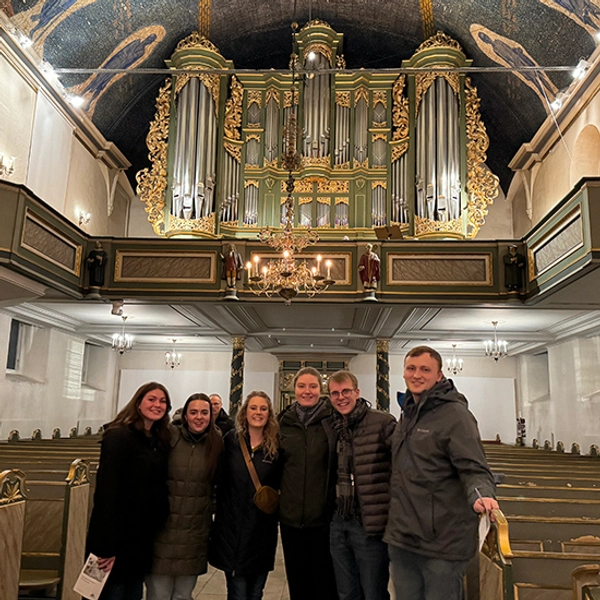 Photo of 6 students in a cathedral on the Sweden choir trip