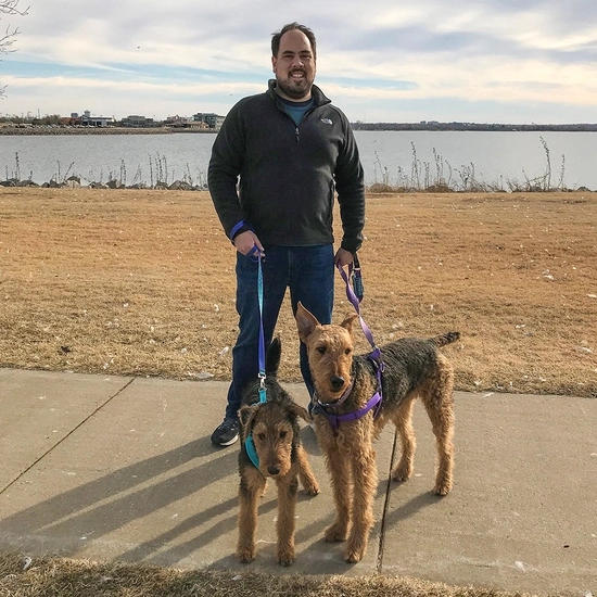Don outside with his two dogs