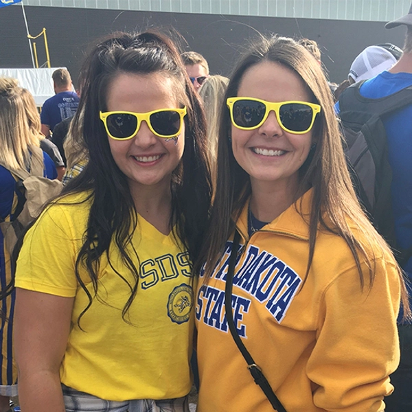 Emily Punt and another female smile, dressed in Jackrabbit gear