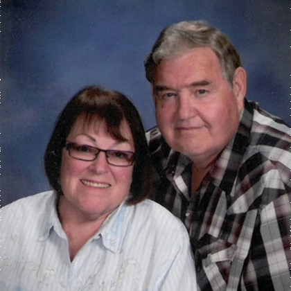Mary and Cal Hayenga smile together for a professional photo.