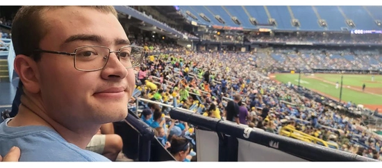Lucas Wintrode sitting in the crowd of a Tampa Rays baseball game.