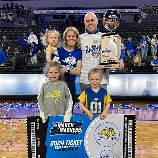 Erin Glidden and her husband Tyler with their three kids with at the Summit League Championship Game