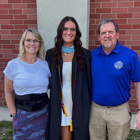Gracie Barber and her parents at her masters graduation ceremony