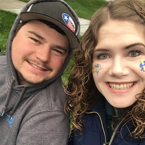 Two people smile for a selfie