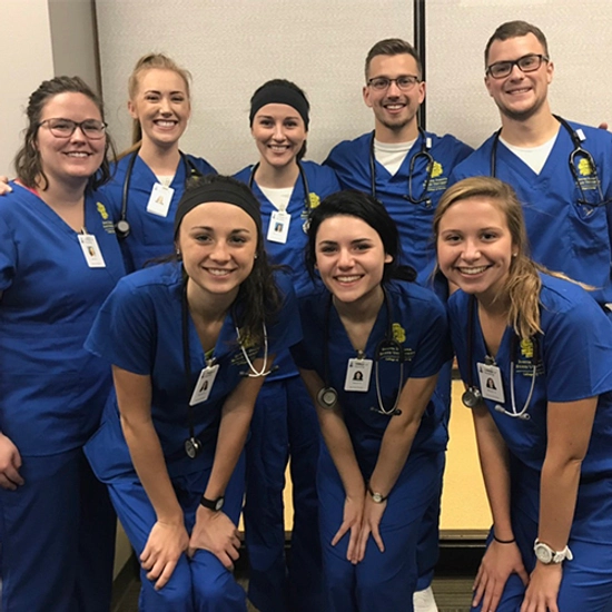 Hanna Eide poses and smiles with SDSU nursing classmates.