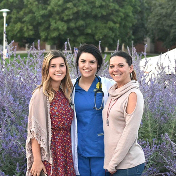 Hanna smiles with her mom and sister on SDSU campus