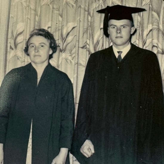 Old photo of a couple in graduation gowns