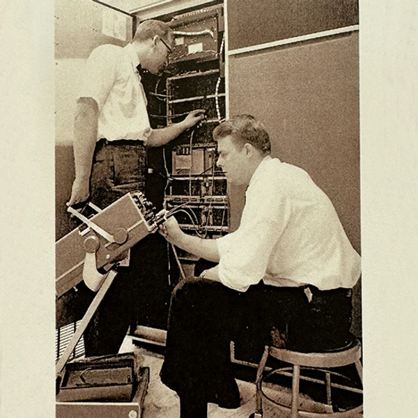 Two men working with electrical cords