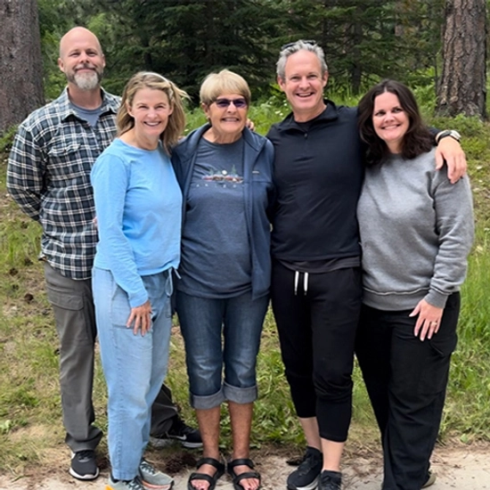Photo of Jennifer Dolan smiling with her family.