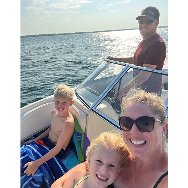 Megan and her husband and their two kids on a boat