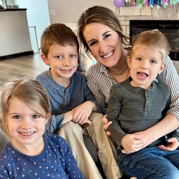 Jenn McCloud smiles with her three young kids