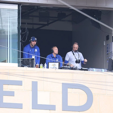 Three men in the announcing booth