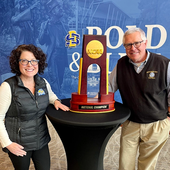Rina and Coach Stig with the NCAA National Championship trophy