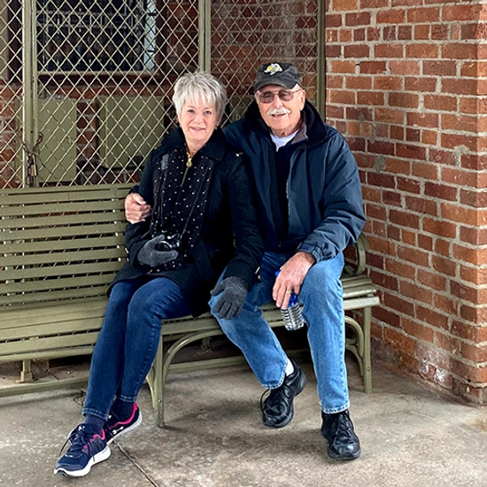 A couple sitting on a bench together