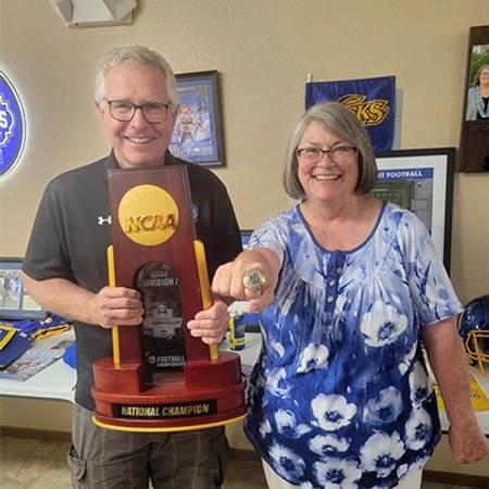 Stig and his wife with the NCAA National Championship trophy