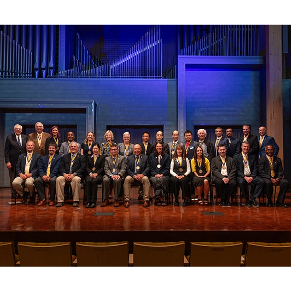 Large group of endowed holders, standing in rows with their medallions around their necks
