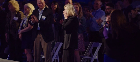 Dr. Diddle covers her mouth in shock as she is named the inaugural recipient of the Paul and Doris Moriarty Professor of Choral Activities.
