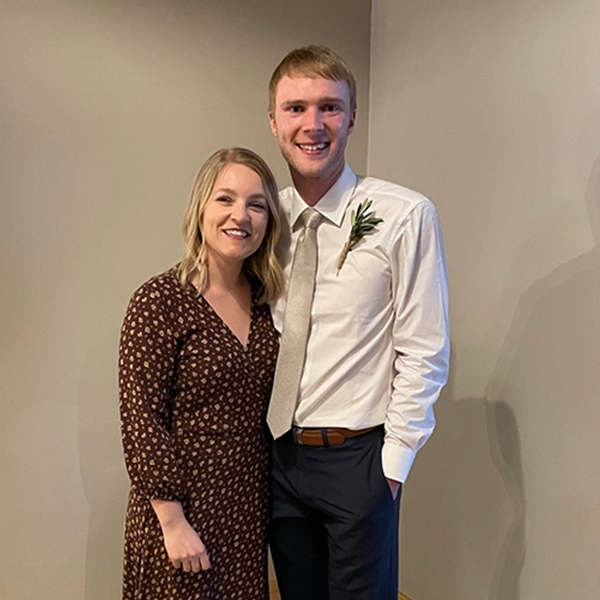 Sydney and Nathan Adrian smiling while enjoying a friend's wedding.