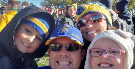 photo of a jackrabbit family smiling during college game day