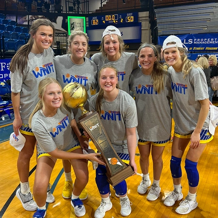 group of sdsu women's basketball hold up the wnit trophy