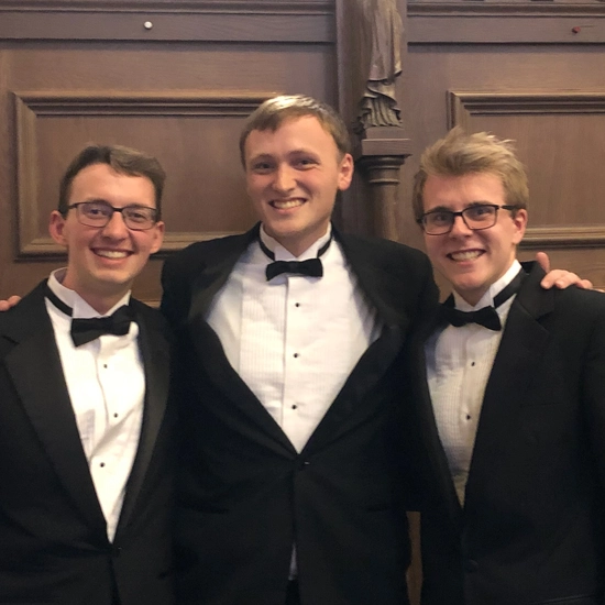 Three sdsu men choir members in tuxedos